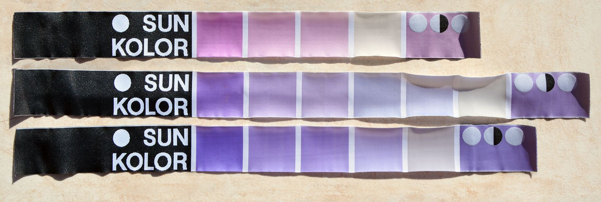 Three fabric strips from sun kolor with colour palettes ranging from pink to beige and light purple.