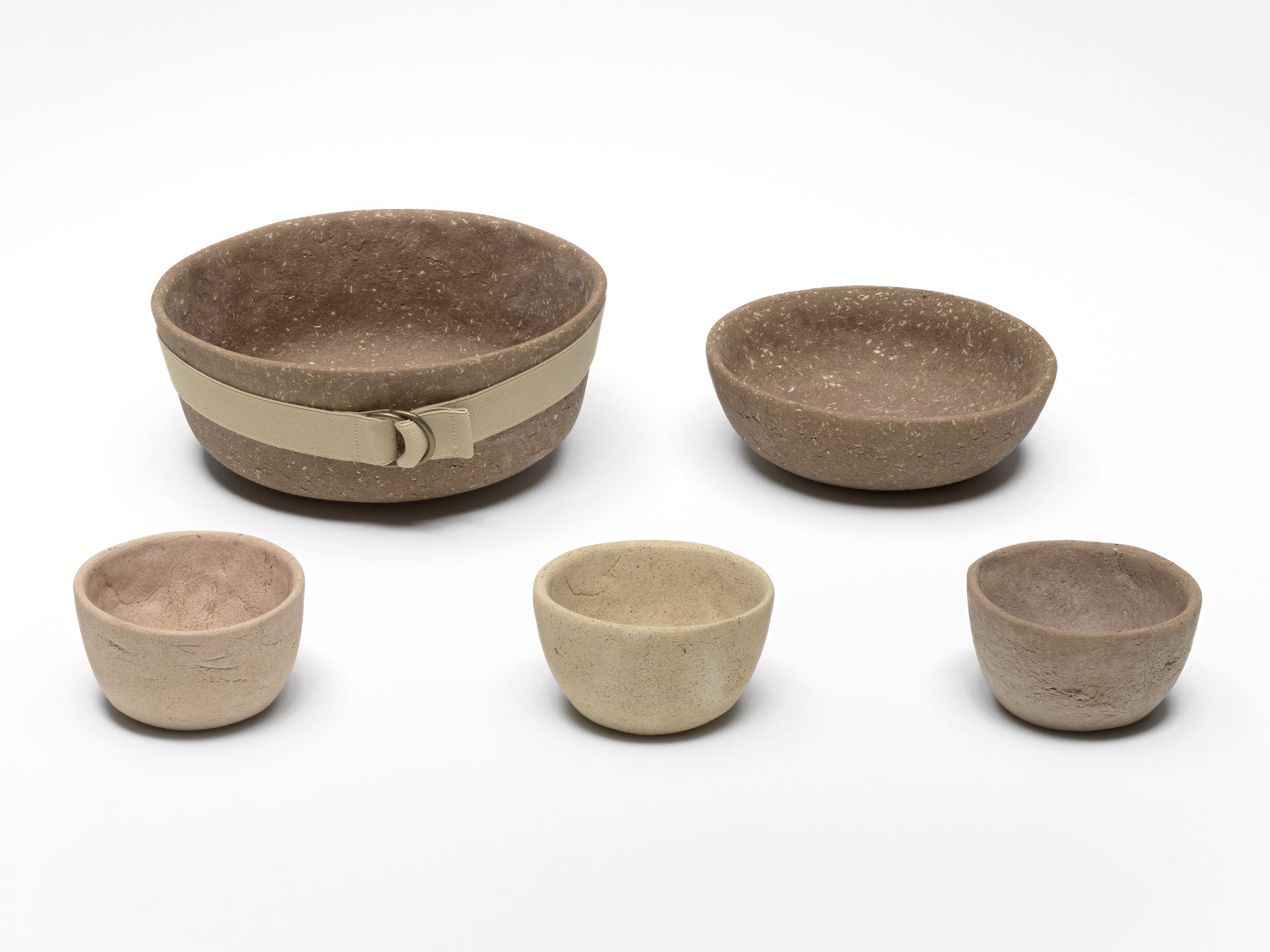 View of five bowls made of biomaterial baked at low temperature, consisting of flour, organic waste and natural limestone