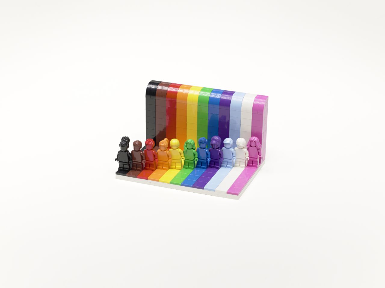 Different Lego play figures in bright colors representing diversity
