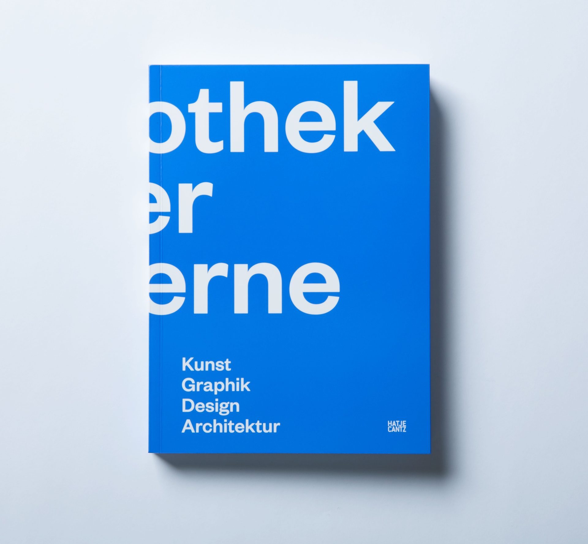 White letters on a blue background. Above opened cover and spine the inscription, Pinakothek der Moderne, cover spine, Art Prints & Drawings Design Architecture, cover front, Art Graphic Design Architecture