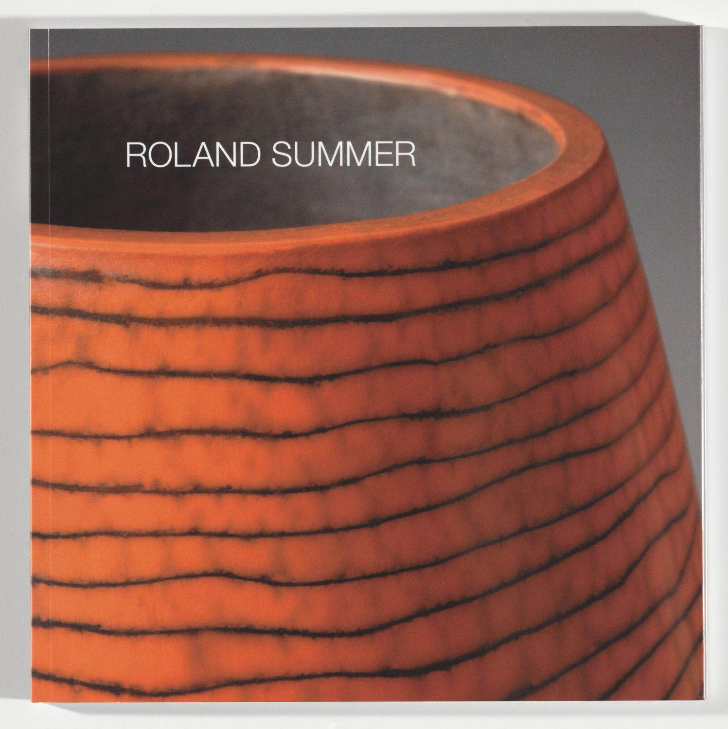 Heavily truncated vase occupying almost the entire picture, terracotta-coloured with black, slightly wavy horizintal lines. Inner glaze, dark grey, with the inscription: Roland Summer.