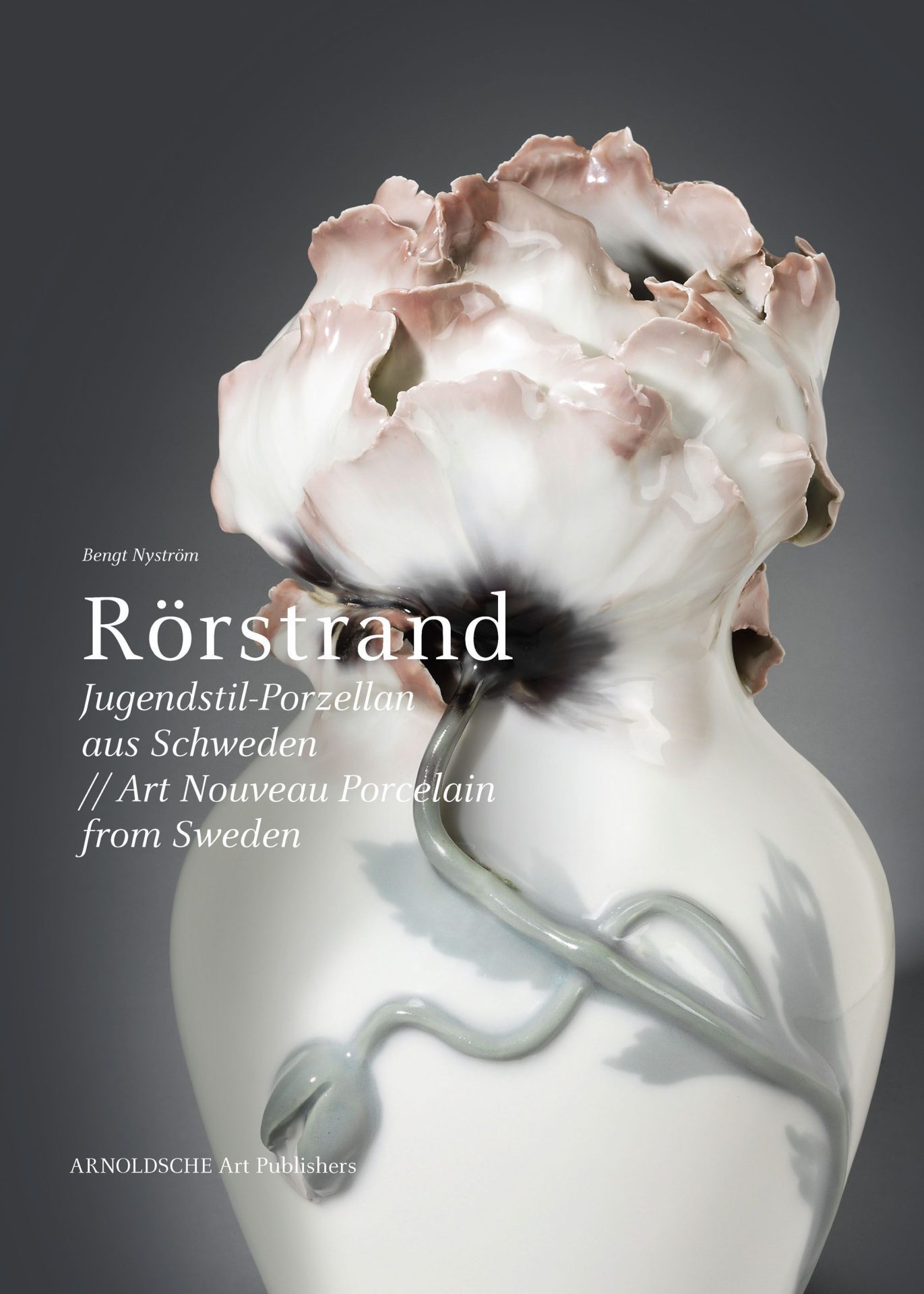 White vase, the lower end of which is cut off. A flower is placed on top, wrapped around the body with grey leaves and stem. The upper end is formed by overlapping petals with pink ends. Labelled in white: Rörstrand Art Noveau Porcelain from Sweden.