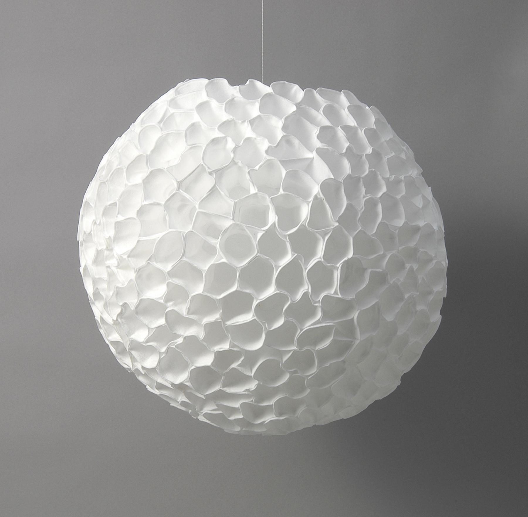 Spherical pendant light with a honeycomb-like, white surface.