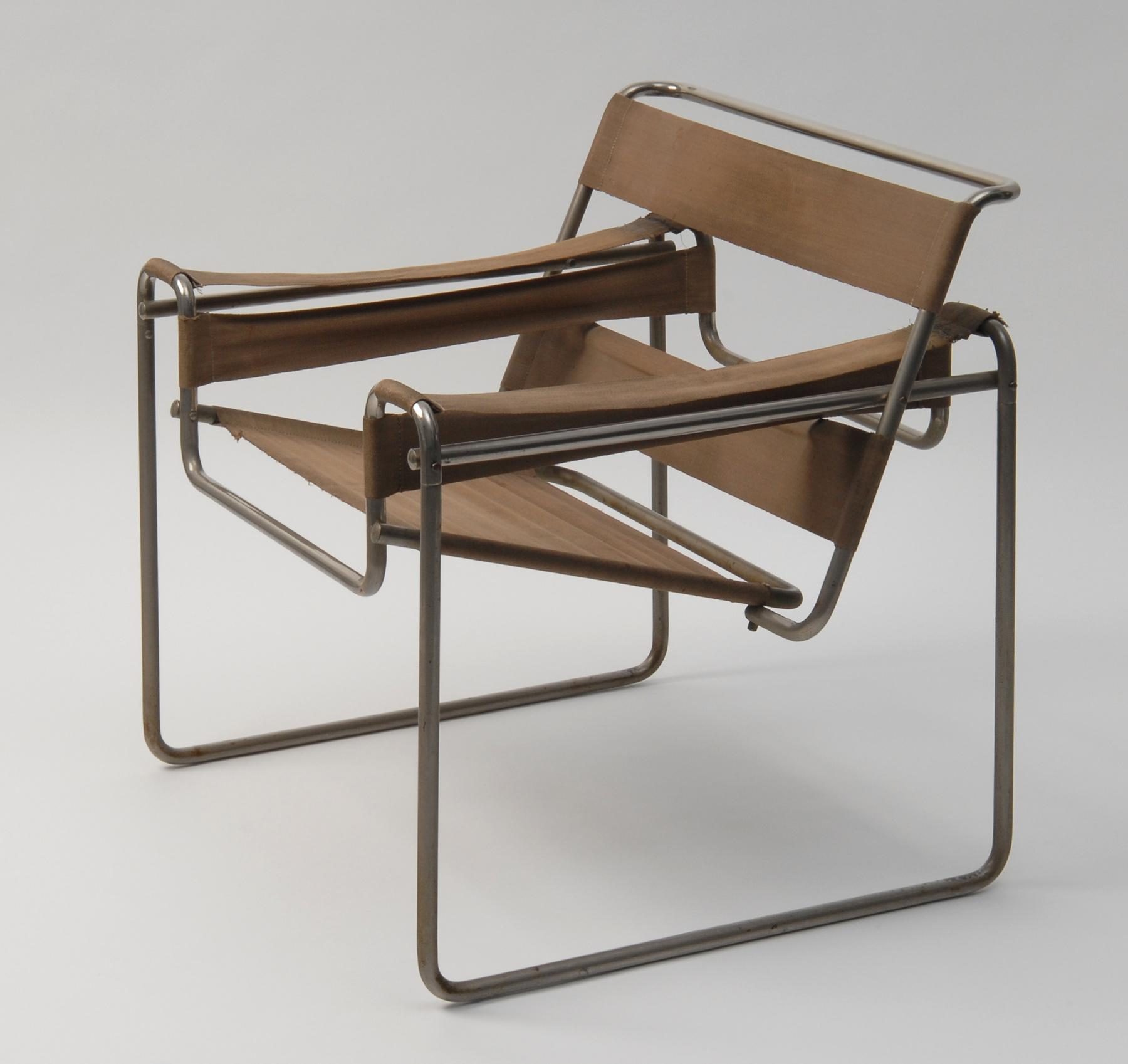 Photo of a chair with a metal frame and brown fabric panels that form the seat, backrest and armrests.