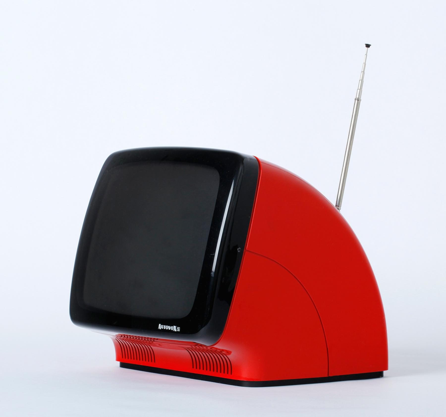 Red television with a curved black screen and an extended telescopic aerial. 