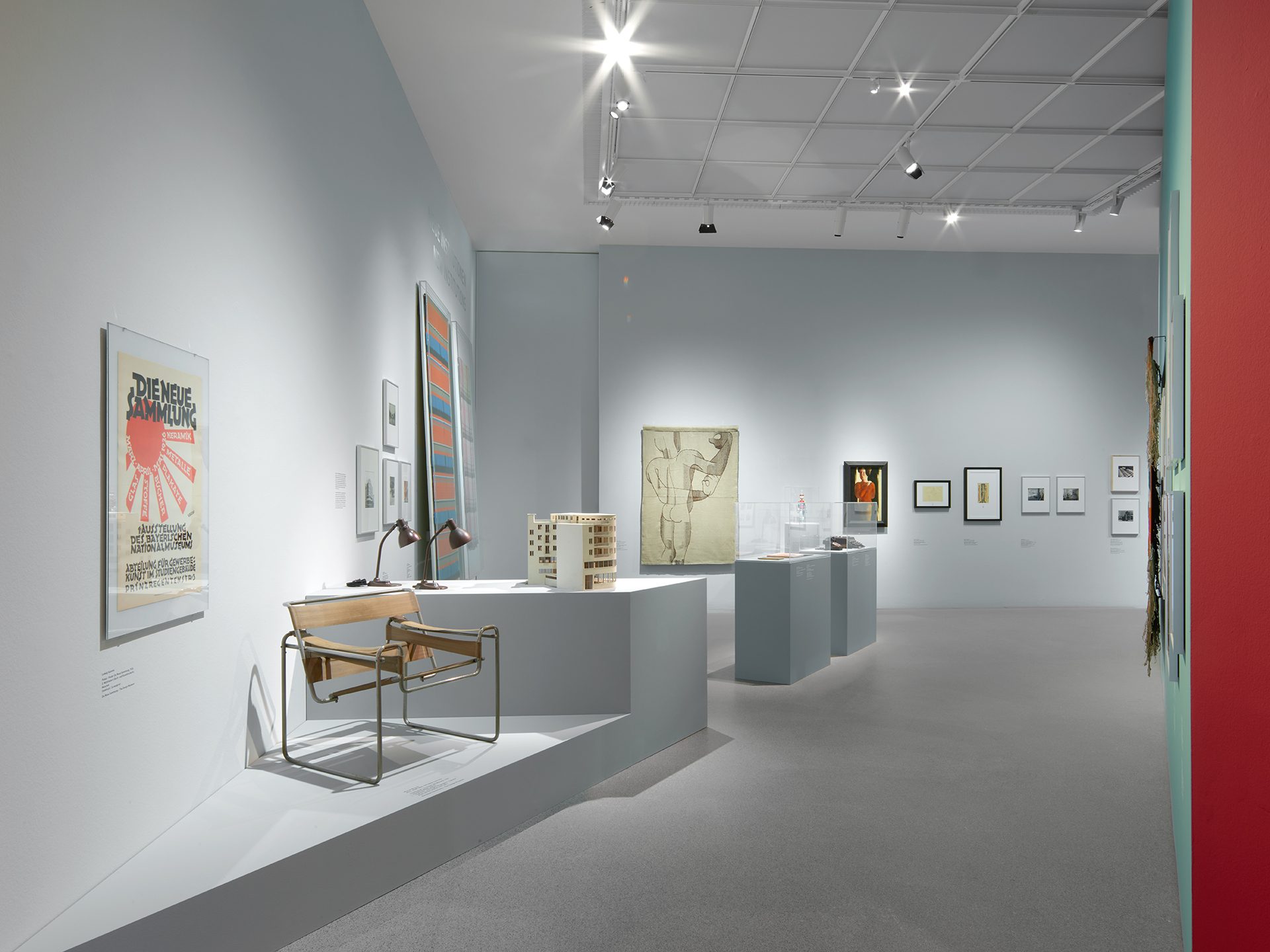 You can see the exhibition installation "4 Museums – 1 Modernism." You can see furniture, objects, and graphics.