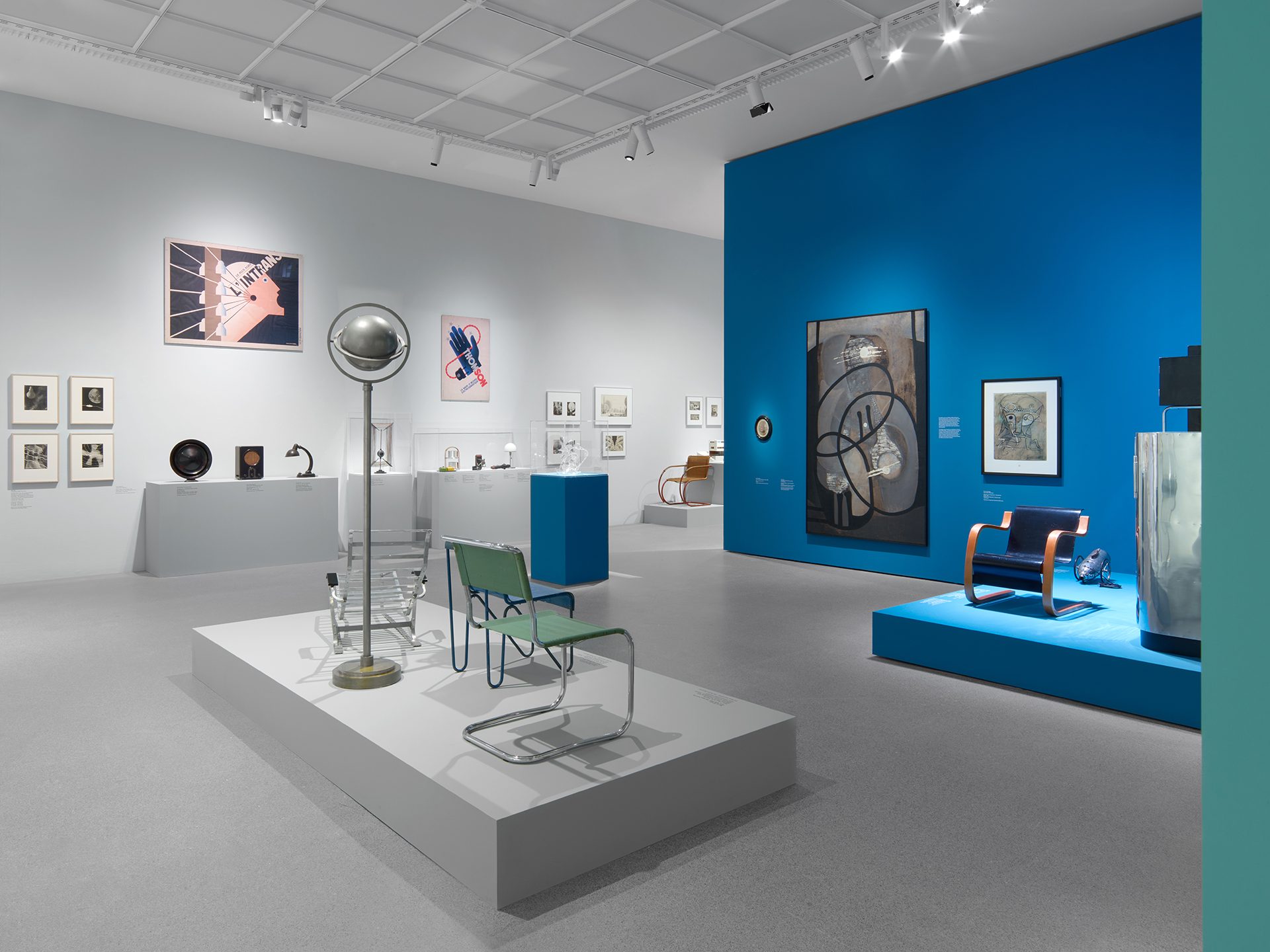 You can see the exhibition installation "4 Museums – 1 Modernism." You can see furniture, objects, and graphics.