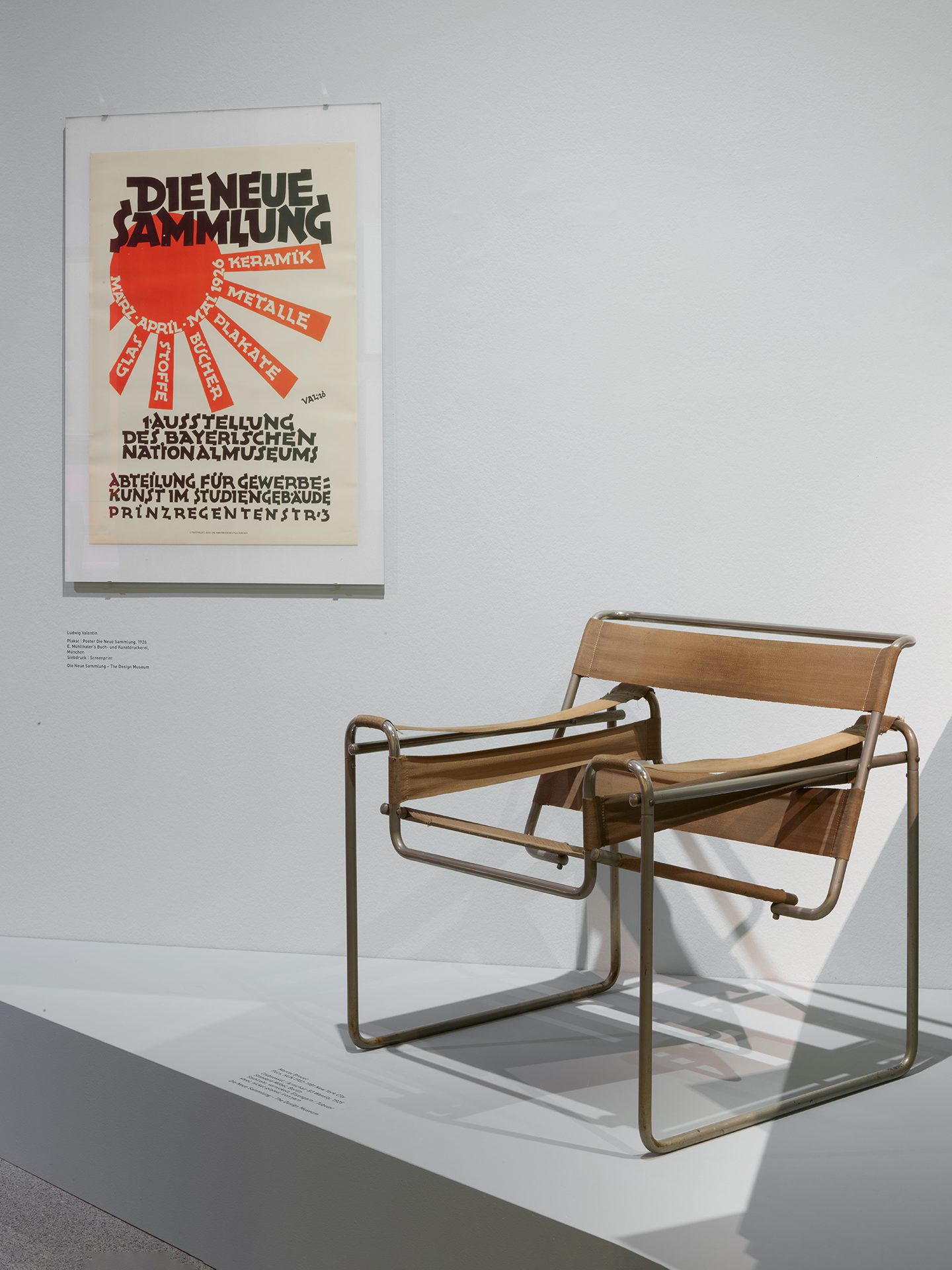 You can see the exhibition installation "4 Museums – 1 Modern." You can see a chair and graphics.
