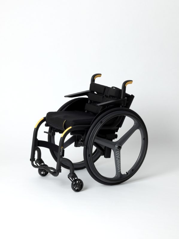 Photo of a black wheelchair with yellow handles against a white background.